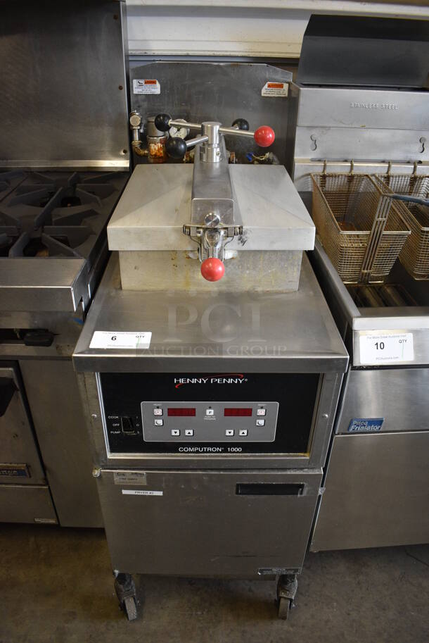 Henny Penny Model 600 Stainless Steel Commercial Floor Style Natural Gas Powered Pressure Fryer on Commercial Casters. 80,000 BTU. 18.5x38x49