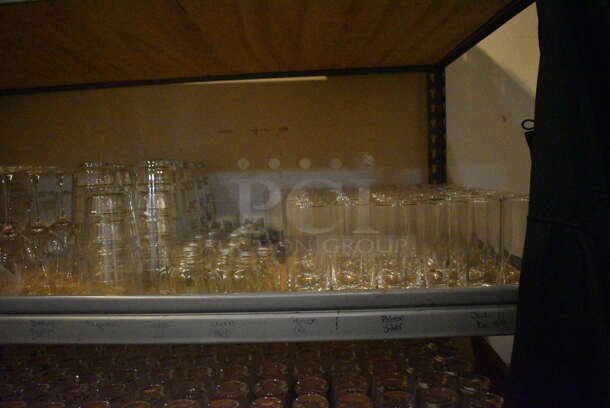 Gray Metal 5 Tier Shelving Unit w/ Contents Including Beverage Glasses and Wine Glasses. 48x24x72. BUYER MUST REMOVE; BUYER MUST DISMANTLE. PCI CANNOT DISMANTLE FOR SHIPPING. PLEASE CONSIDER FREIGHT CHARGES. (glass room - off of bar area) - Image 4 of 10