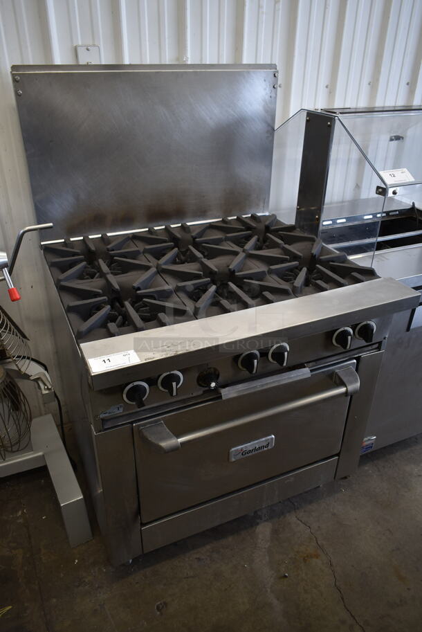 Garland G36-6R Stainless Steel Commercial Natural Gas Powered 6 Burner Range w/ Oven and Back Splash.