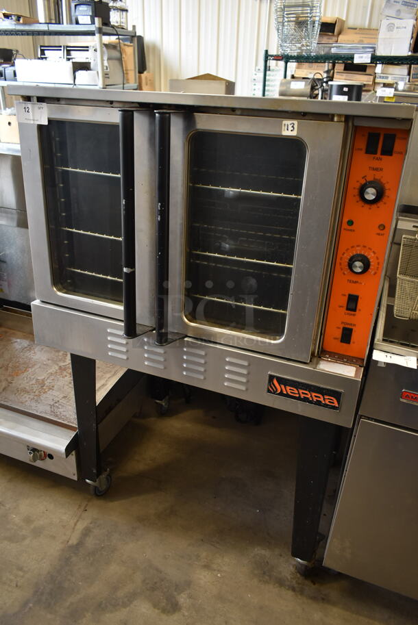 Sierra Stainless Steel Commercial Propane Gas Powered Full Size Convection Oven w/ View Through Doors, Metal Oven Racks and Thermostatic Controls on Metal Legs.