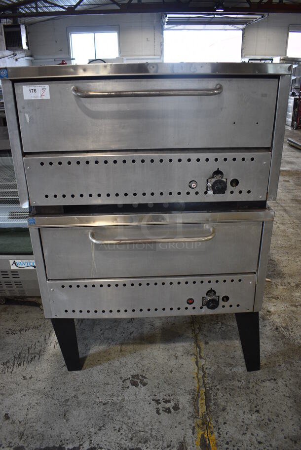 2 Stainless Steel Commercial Gas Powered Single Deck Pizza Oven w/ Cooking Stones on Metal Legs. Appears To Be Comstock Prince Castle Brand. 44.5x36x65. 2 ED250-BCZ