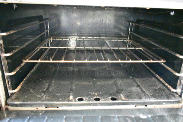 Garland M44R Stainless Steel Commercial Natural Gas Powered 4 Burner Range w/ Oven, Over Shelf and Back Splash on Commercial Casters.  - Image 5 of 9