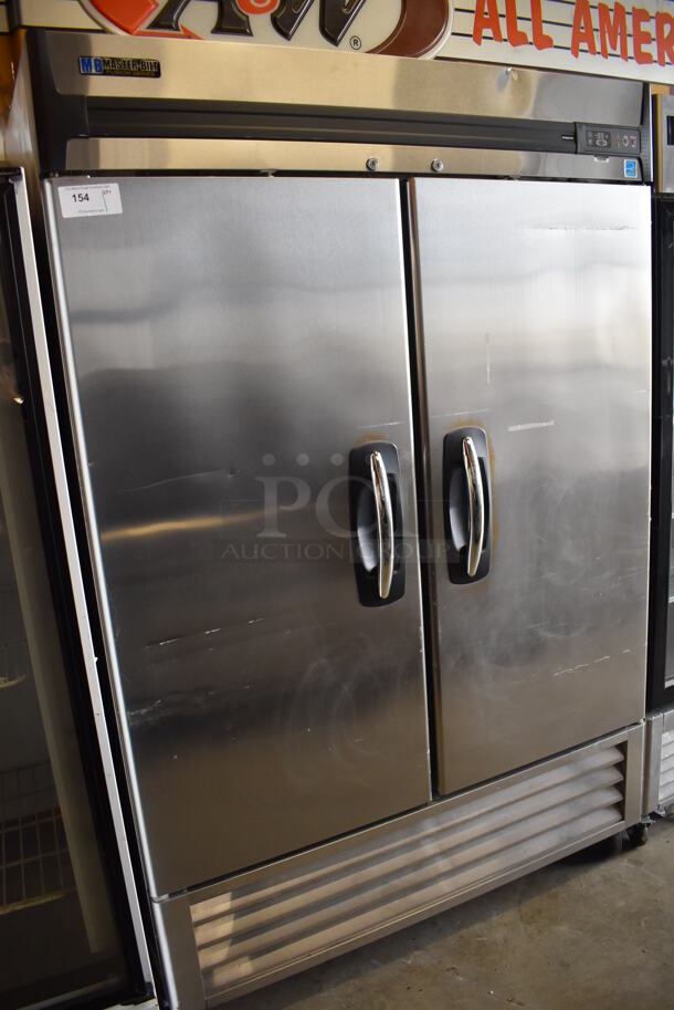 Master-Bilt R49-S Stainless Steel Commercial 2 Door Reach In Cooler w/ Poly Coated Racks on Commercial Casters. 115 Volts, 1 Phase. 54.5x31.5x83.5. Tested and Powers On But Does Not Get Cold