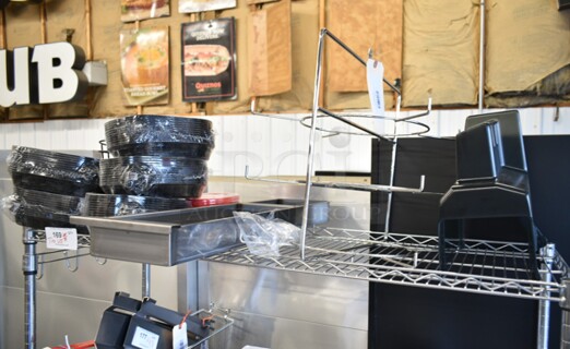 BRAND NEW SCRATCH AND DENT! Tier Lot of Various Items Including Hobart Tenderizer Lid, 41341764000Hatco 04.17.640.00 Fsd 3 Tier Circle Rack W/Ret, HP0049808200 Vulcan 00-498082-0000A Grease Can Weldment, 176STRND7BK Acopa 7" Round Black Metal Display Stand, 176BSKT95RD Choice 9 1/4" x 5 3/4" x 1 1/2" Red Oval Plastic Fast Food Basket - 12/Pack, 176BSKT117BK Choice 11" x 7" x 1 1/2" Black Oval Plastic Fast Food Basket - 12/Pack