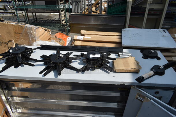 BRAND NEW SCRATCH AND DENT! Lot of 19 Lancaster Table and Seating Items Including 164TB5222 5" x 22" Straight Cast Iron Table Base Plate, 164STS1000 Cast Iron Table Base Spider, 9 164TS1800 18" Cast Iron Table Base Spider and 4 Metal Legs.  - Image 1 of 12