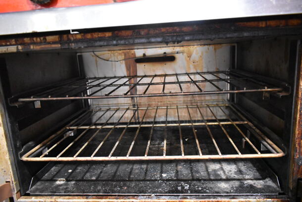 Vulcan 36XTL-559 Stainless Steel Commercial Propane Gas Powered Flat Top Griddle w/ Oven, Over Shelf and Back Splash on Commercial Casters.  - Image 5 of 6