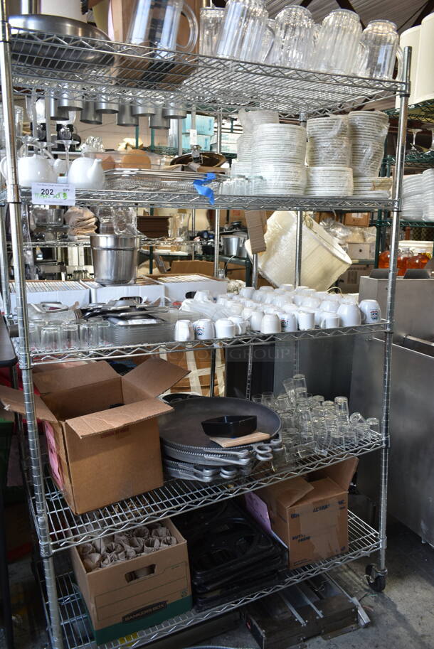 ALL ONE MONEY! 5 Tiers of Various Items Including Poly Pitchers, Ceramic Dishes, Glassware. Does Not Include Shelving Unit.  - Image 1 of 12