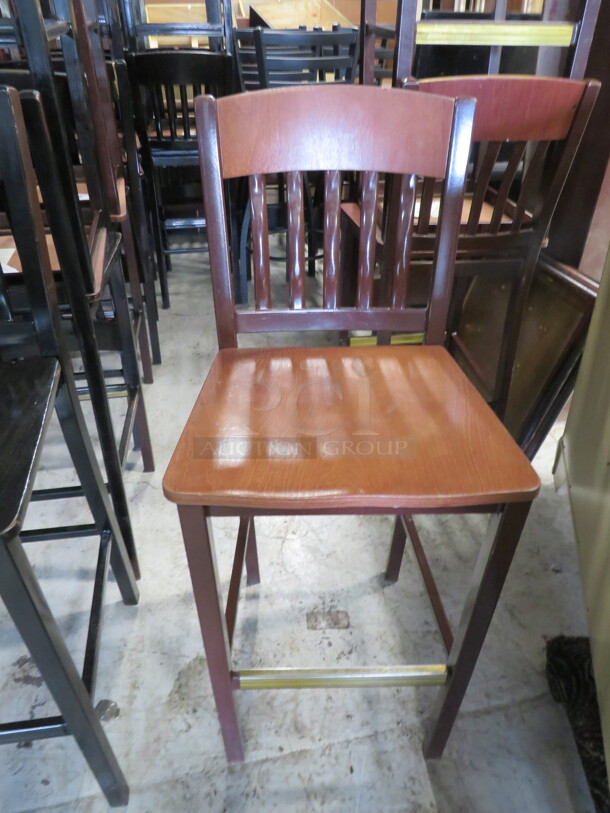 One Metal Bar Height Chair With A Black Wooden Seat. 