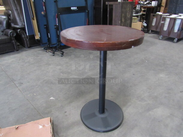 One Round Bar Height Wooden Table With A Heavy Laquered Top On A Pedestal Base. 30X30X41
