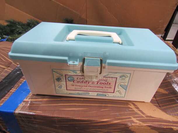 One NEW Wilton Cake Decorating Caddy With Supplies.