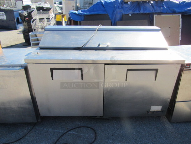 One SS True 2 Door Refrigerated Prep Table With 2 Racks On Casters. Model# TSSU-60-16. 115 Volt. 60X30X42.5