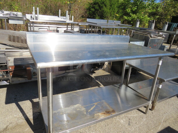 One Stainless Steel Table With Back Splash And SS Under Shelf. 60X30X39 - Image 1 of 1