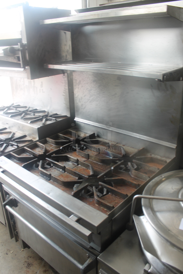 Stainless Steel Commercial Natural Gas Powered 4 Burner Range w/ Oven, 2 Tier Over Shelf and Back Splash. - Image 1 of 6