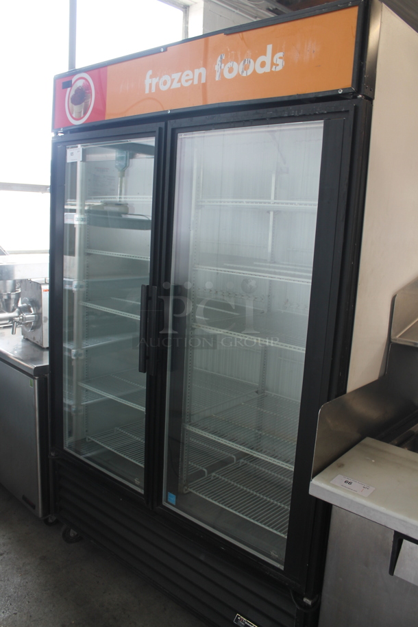 2011 True GDM-49F ENERGY STAR Metal Commercial 2 Door Reach In Freezer Merchandiser w/ Poly Coated Racks on Commercial Casters. 115/208-230 Volts, 1 Phase.  - Image 1 of 8