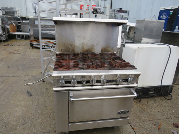 One DCS Natural Gas 6 Burner Range With SS Over Shelf. 36X33X56 - Image 1 of 2