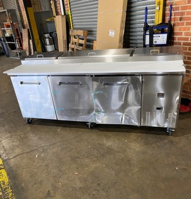 NICE! SCRATCH-N-DENT! Kelvinator Commercial Refrigerated Pizza Prep Table! With Commercial Cutting Board! With 3 Door Storage Space Underneath! All Stainless Steel! On Casters! Model: KCHPT9212 SN: 93610053 115V