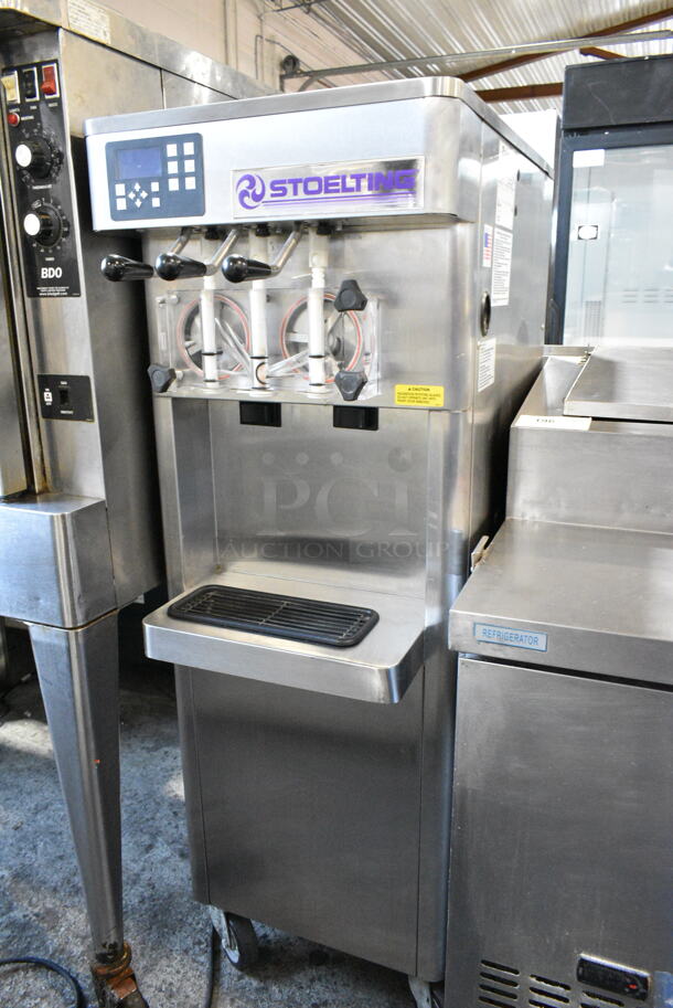 Stoelting F231-109I2YGAD1 Stainless Steel Commercial Floor Style Water Cooled 2 Flavor w/ Twist Soft Serve Ice Cream Machine on Commercial Casters. 208-240 Volts, 3 Phase. - Image 1 of 8