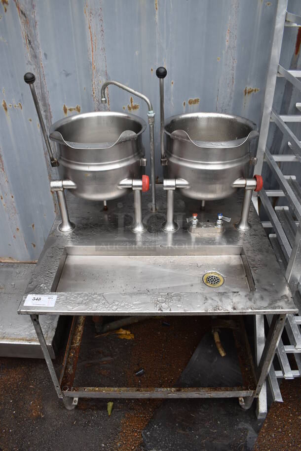Stainless Steel Commercial Floor Style Tilting Kettle Station w/ 2 Tilting Kettles. Appears To Be Steam Powered. 35.5x34x55