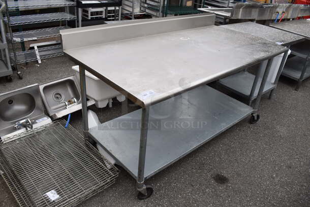 Stainless Steel Table w/ Back Splash and Metal Under Shelf on Commercial Casters.