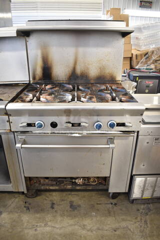 Stainless Steel Commercial Natural Gas Powered 6 Burner Range w/ Oven, Over Shelf and Back Splash on Commercial Casters. 