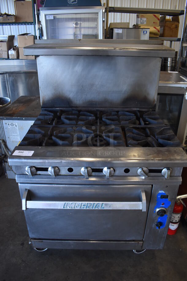 Imperial Stainless Steel Commercial Natural Gas Powered 6 Burner Range w/ Convection Oven, Over Shelf and Back Splash on Commercial Casters. 36x33x57