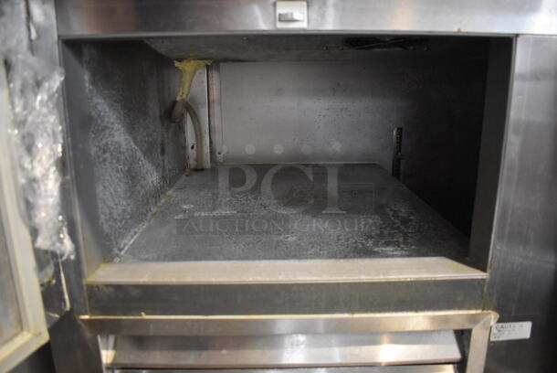 2014 Model Leader ESPT72SC Commercial Stainless Steel Electric Powered Pizza Prep Table With Enclosed Top For Plastic Ingredient Pans, Marble Style Prep Counter With Polycoated Racks on Commercial Casters. 115V Tested And Powers On But Does Not Get Cold - Image 6 of 9