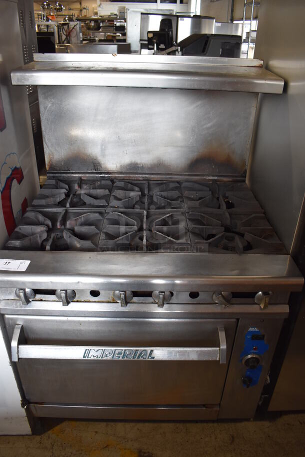 Imperial Stainless Steel Commercial Natural Gas Powered 6 Burner Range w/ Convection Oven, Over Shelf and Back Splash on Commercial Casters. 36x34x57