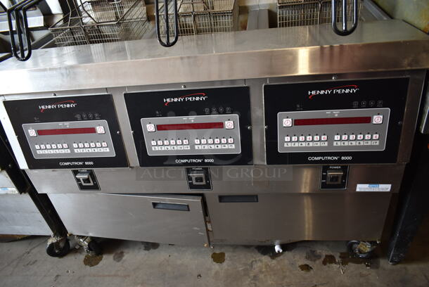 2020 Henny Penny OGA-323 ENERGY STAR Stainless Steel Commercial Natural Gas Powered 3 Bay Fryer w/ 3 Metal Fry Baskets on Commercial Casters. 255,000 BTU.  - Image 2 of 12