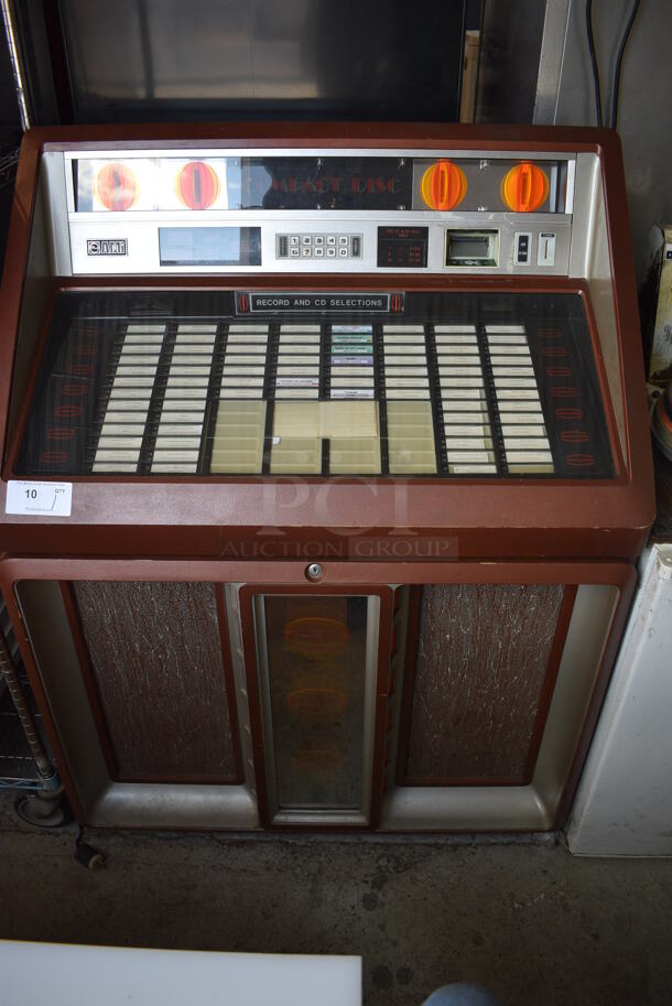 AMI Metal Commercial Floor Style Jukebox. 41x27x54. Tested and Powers On - Cannot Test Without Key