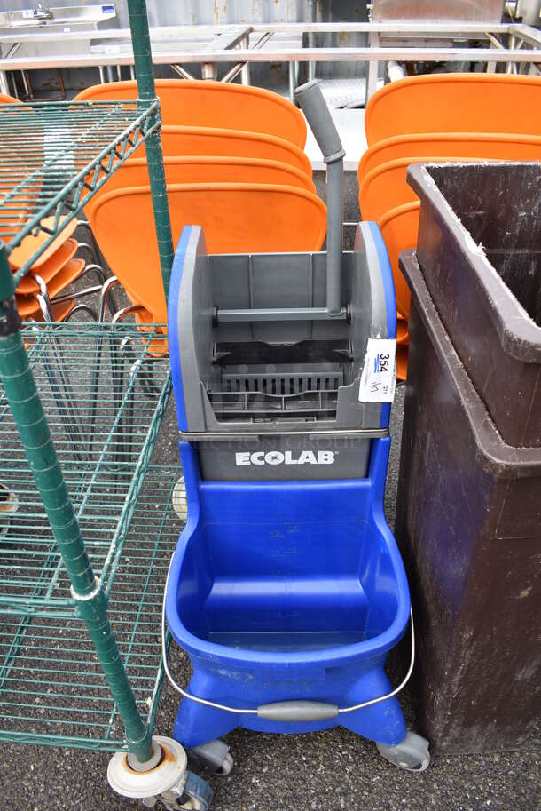 Ecolab Blue and Gray Poly Mop Bucket w/ Wringing Attachment on Commercial Casters. 15x20x40