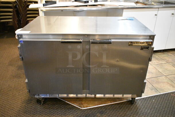 Beverage Air UCR48A Stainless Steel Commercial 2 Door Undercounter Cooler on Commercial Casters. 115 Volts, 1 Phase. This Unit Was In Working Condition When the Restaurant Closed. (main dining room)  - Image 1 of 5