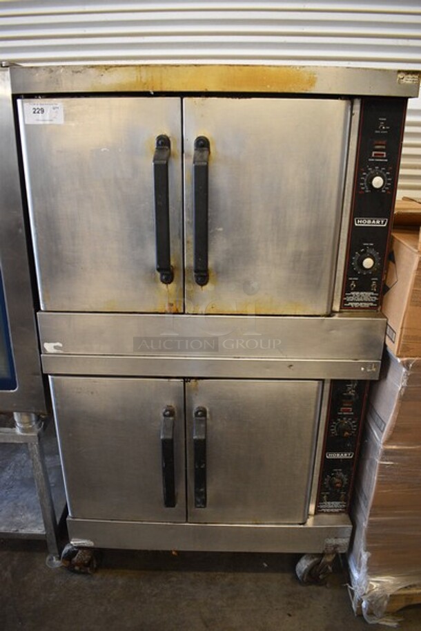 2 Hobart Stainless Steel Commercial Natural Gas Powered Full Size Convection Oven w/ Solid Doors, Metal Oven Racks and Thermostatic Controls on Commercial Casters. 40x33x69.5. 2 Times Your Bid!