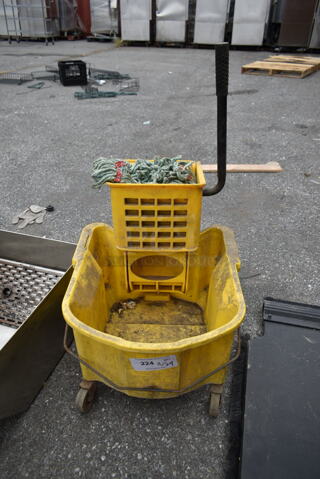 Yellow Poly Mop Bucket w/ Wringing Attachment on Commercial Casters.