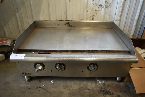 APW Wyott Stainless Steel Commercial Countertop Natural Gas Powered Flat Top Griddle.  - Image 1 of 7