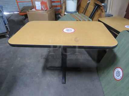 One Brown Laminate Table Top On A Pedestal Base. 42X26X29.5