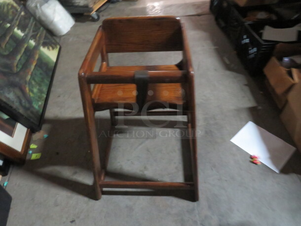 One Wooden High Chair With Safety Straps.