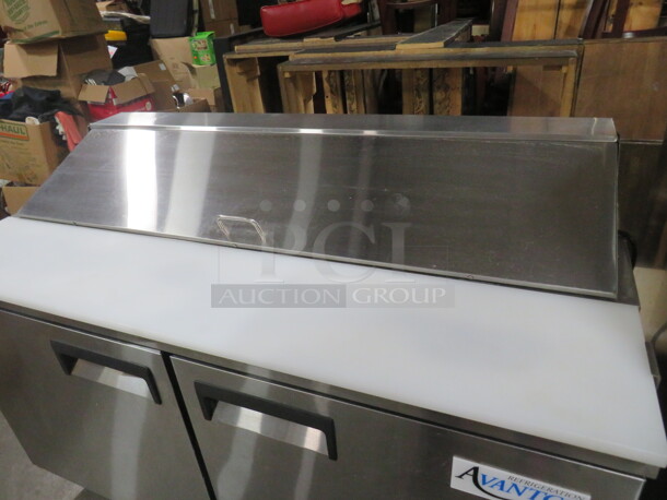 One Working Avantco 2 Door Refrigerated Prep Table With 2 Racks, And  Cutting Board On Casters. Model# 178APT60HC. 115 Volt. 60X31X43. - Image 5 of 5