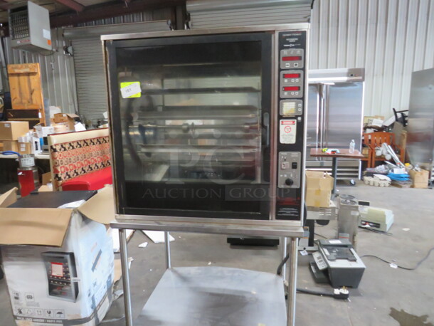 One Henny Penny Rotisserie On A SS Stand On Casters. Model# SCR-8. 208 Volt. 3 Phase. 40X35X73.5