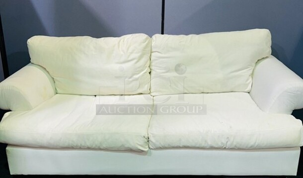 Off white colored love seat- In good condition. Has discoloration spotting on left side, hard to photograph. Can be dyed or reupholstered. No tears, comfy and plush. 82” W x 42” H x 43” D - Image 2 of 2