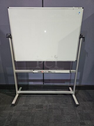 VizPro Dry erase whiteboard on wheels with silver metal framing. Double sided. In good used condition- not broken. 69"H x 52"W x 22"D