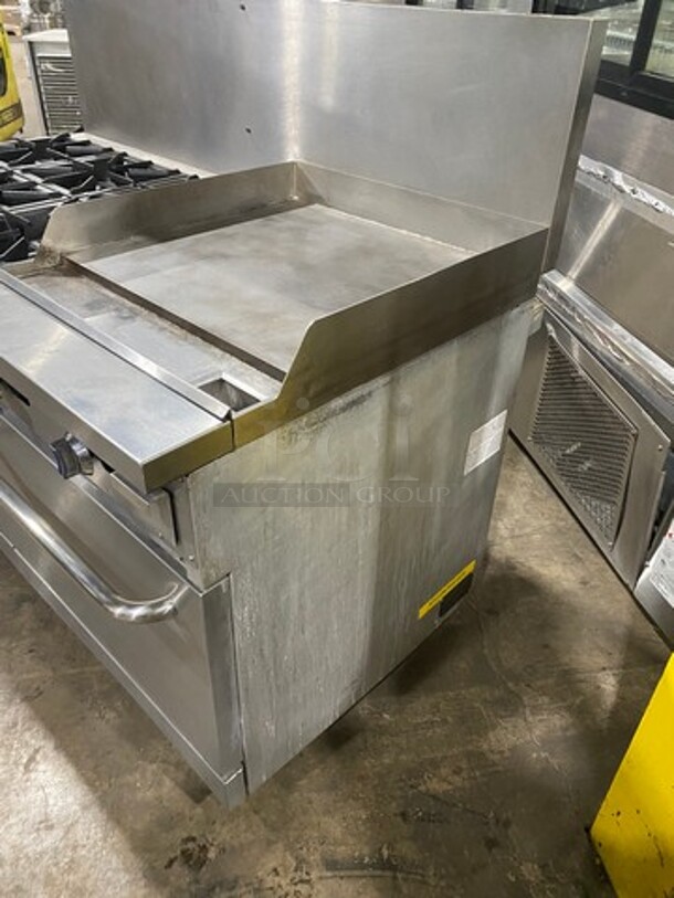 Patriot Commercial Natural Gas Powered 6 Burner Stove With Flat Griddle! Flat Griddle Has Side Splashes! With Raised Back Splash! With 2 Oven Underneath! Metal Oven Racks! All Stainless Steel! On Casters! Model: FMGR6024GNG SN: 17035100006 - Image 2 of 12