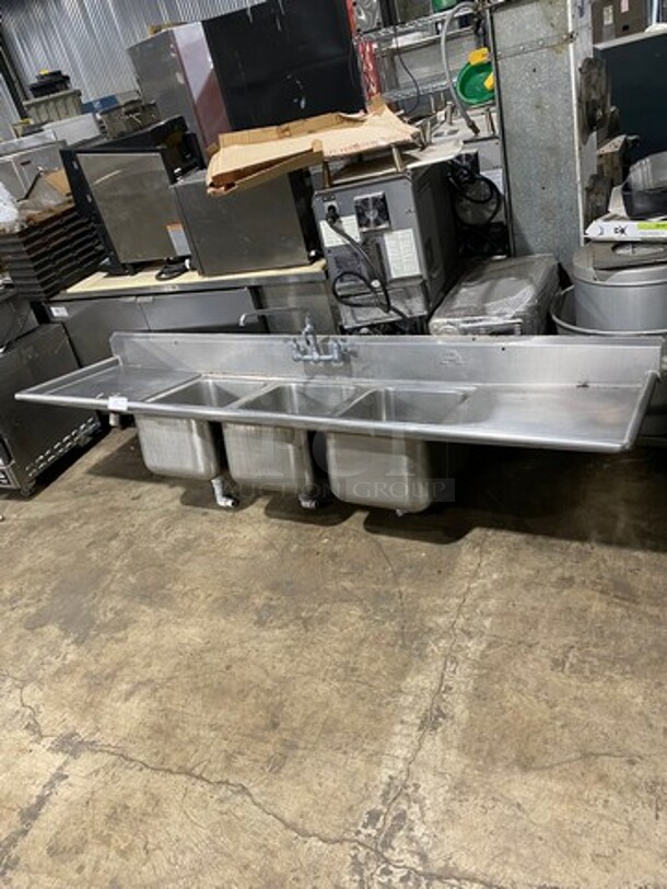 Commercial 3 Compartment Dish Washing Sink! With Dual Side Drain Board! With Faucet And Handles! With Back Splash! All Stainless Steel! With Legs! - Image 1 of 8