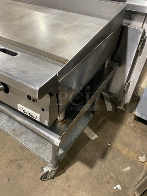 NICE! Garland Heavy Duty Commercial Countertop Gas Powered Flat Griddle! 1-Inch-Thick Plate! With Back And Side Splashes! On Equipment Stand! With Storage Space Underneath! All Stainless Steel! Model GTGG72G72M Serial 1303100100266! On Casters! WORKING WHEN REMOVED! - Image 3 of 9