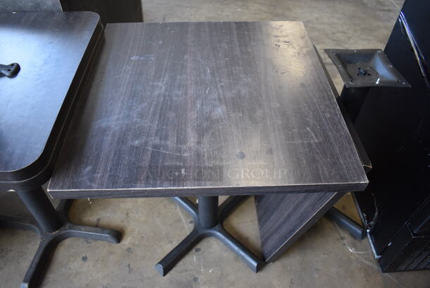 3 Dark Wood Pattern Tabletops on Black Metal Table Base. One Tabletop Is Detached From Its Base. 24x24x29. 3 Times Your Bid!