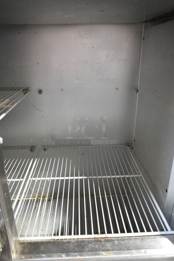 Traulsen G20000 Stainless Steel Commercial 4 Half Size Door Reach In Cooler w/ Poly Coated Racks. 115 Volts, 1 Phase. Tested and Powers On But Does Not Get Cold 
 - Image 4 of 7