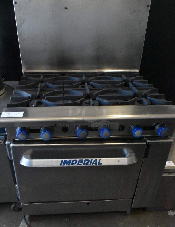 Imperial Stainless Steel Commercial Natural Gas Powered 6 Burner Range w/ Oven and Back Splash on Commercial Casters. 