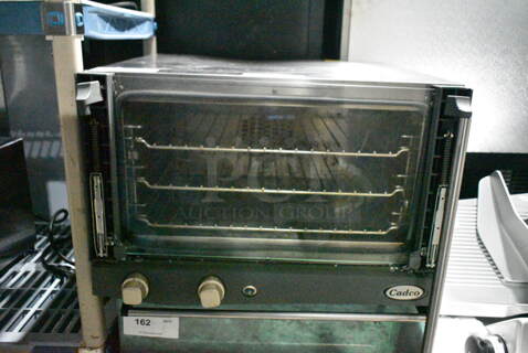 2016 Cadco XAF013 Lisa Stainless Steel Commercial Countertop Electric Powered Convection Oven w/ View Through Door and Metal Oven Rack. See Pictures for Broken Glass on Door. 120 Volts, 1 Phase. Tested and Working!