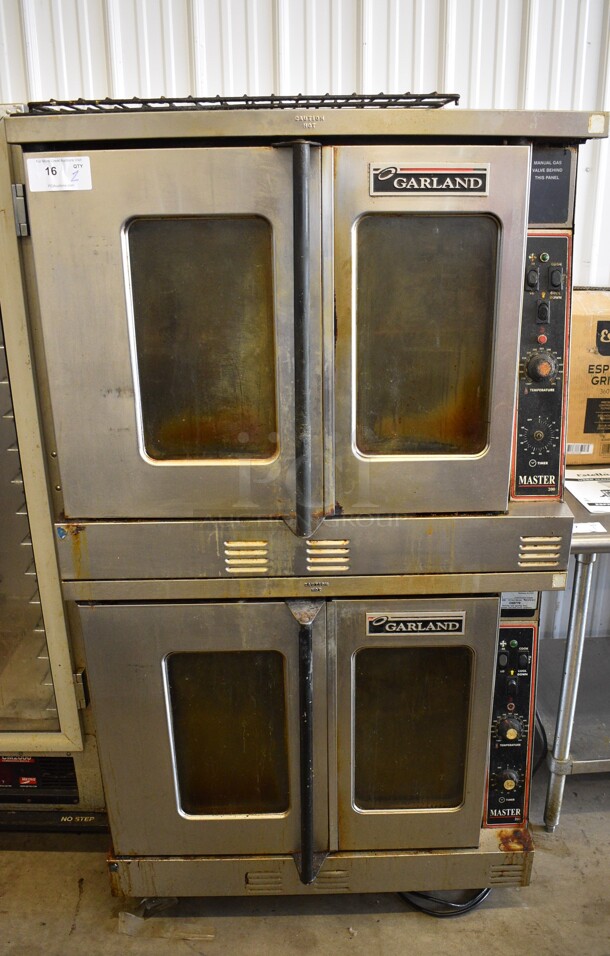 2 Garland Master 200 Stainless Steel Commercial Natural Gas Powered Full Size Convection Oven w/ View Through Doors, Metal Oven Racks and Thermostatic Controls on Commercial Casters. 38x37x68. 2 Times Your Bid!