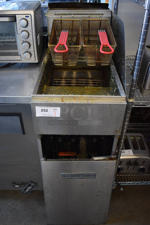 American Range Stainless Steel Commercial Floor Style Gas Powered Deep Fat Fryer w/ 2 Metal Fry Baskets. Door Needs To Be Reattached. 15.5x32x47
