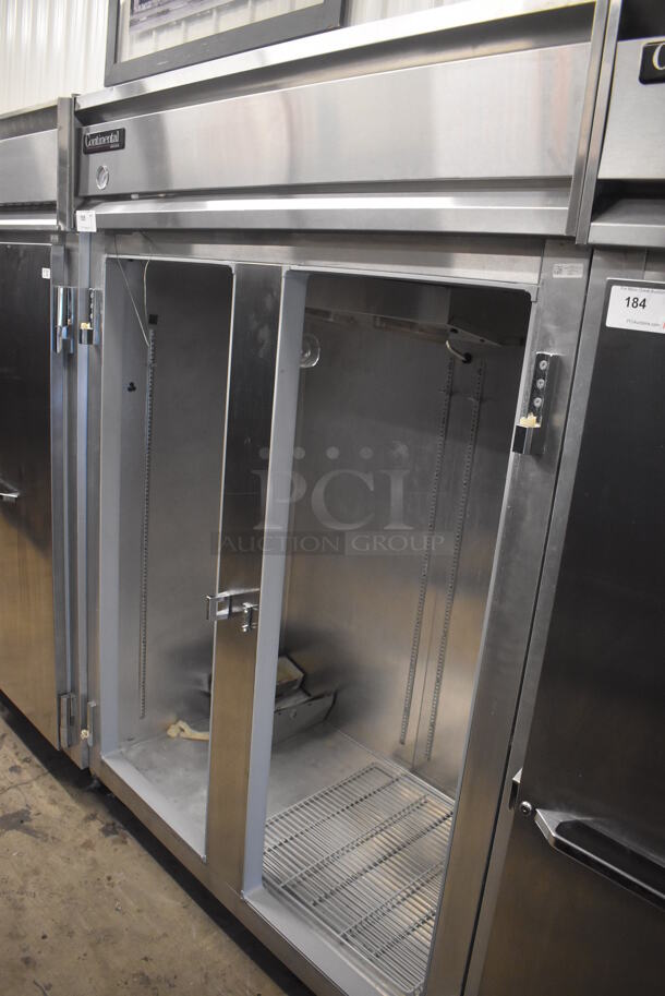 Continental 2FE Stainless Steel Commercial 2 Door Reach In Freezer on Commercial Casters. Missing Doors. 115 Volts, 1 Phase. 57x34x82. Cannot Test - Unit Trips Breaker
